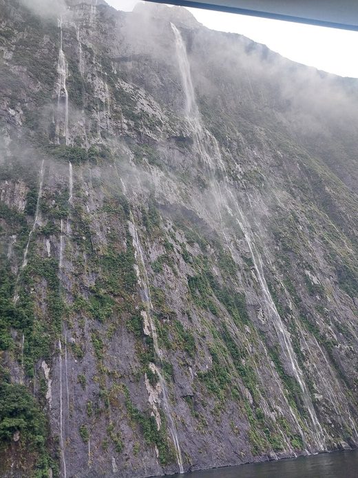 Very high waterfalls at Piopiotahi (Milford Sound), New Zealand